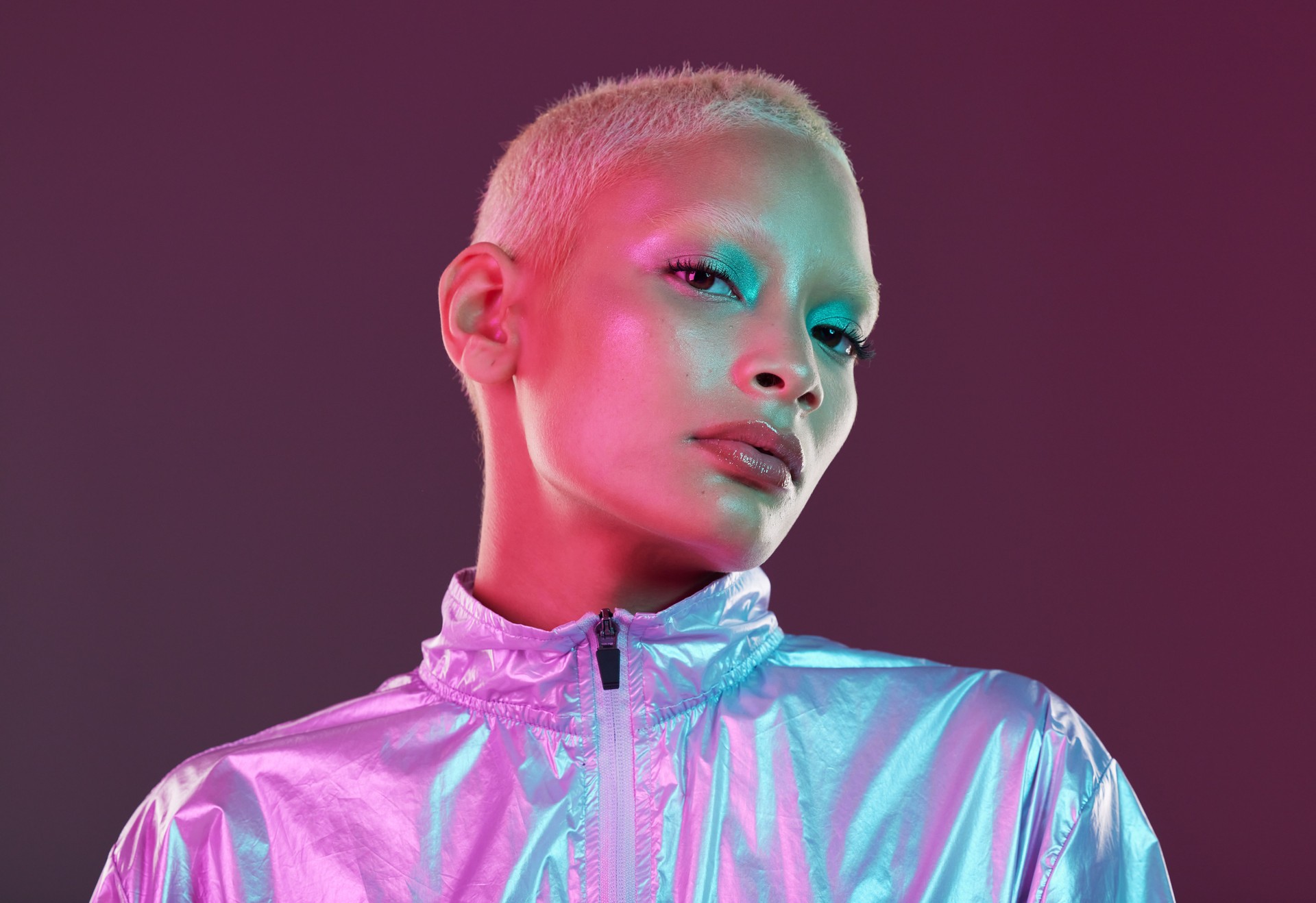 Futuristic fashion, cyberpunk portrait and black woman with chrome clothing in studio. Vaporwave, isolated and gen z with a young female model glow with cosmetics and scifi clothes with mockup