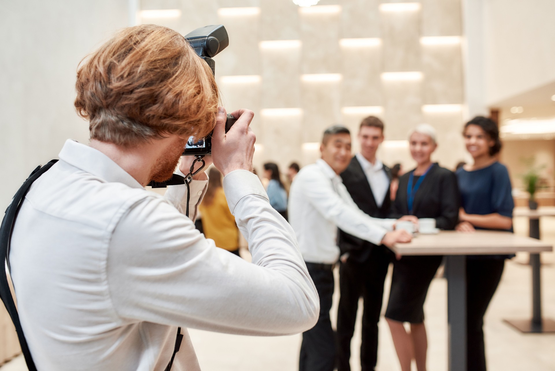 A moment to remember. Close up of photographer taking photo of businesspeople during coffee break at conference